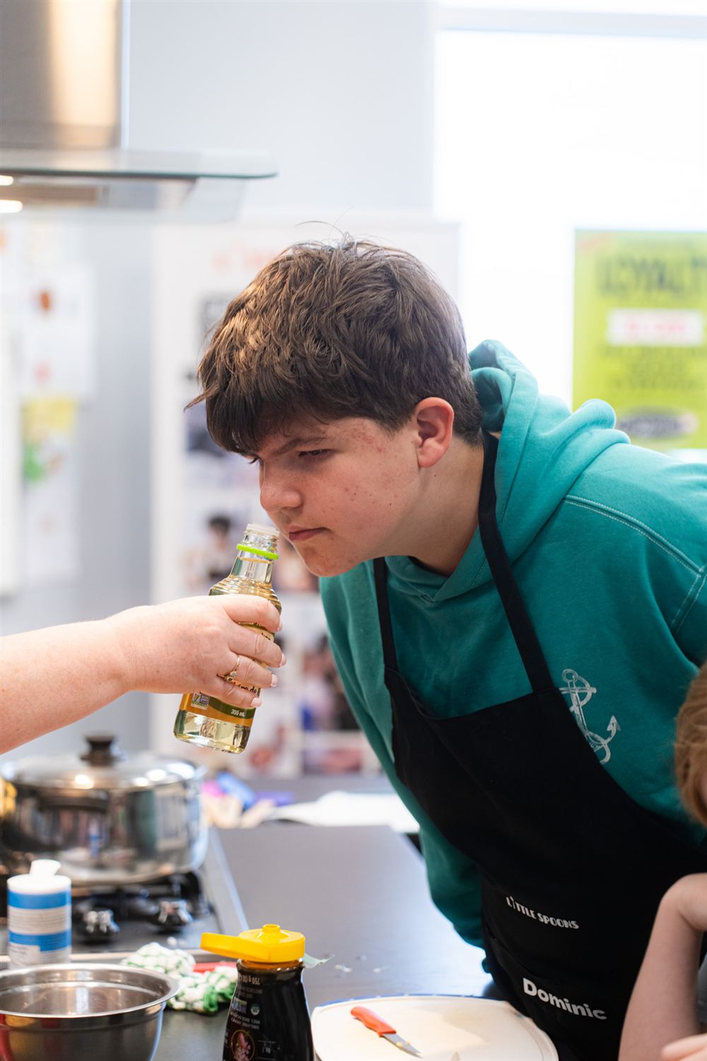 A student in his personalized Little Spoons apron